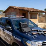 Viatura da polícia em Ponte Alta Norte com armas confiscadas, representando prisão por violência doméstica e posse irregular de armas.